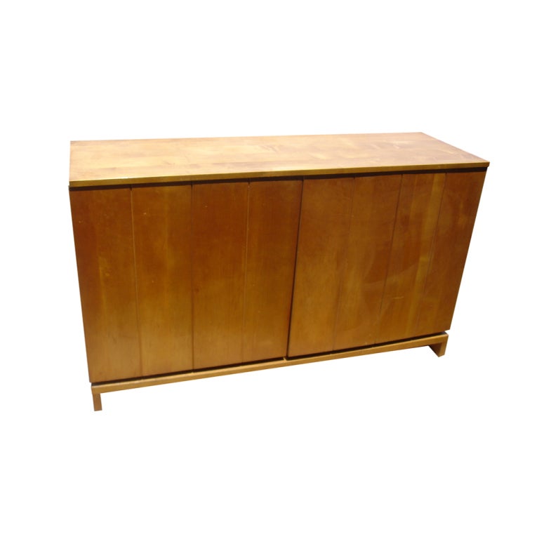 A mid century modern buffet designed by Hendrik Van Keppel and Taylor Green and made by Brown Saltman constructed of solid maple.  A pair of bi-fold doors conceal shelved storage and five drawers, including one cork-lined flatware drawer.  