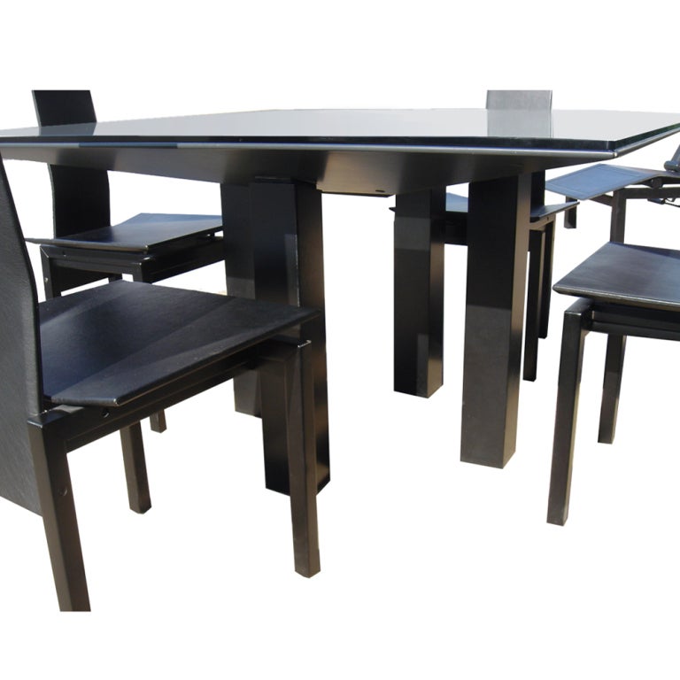 A postmodern Alveo dining table and four chairs from the Memphis school made in Italy and sold by Domus.  The table is in the form of an inverted pyramid with a clear glass center insert on four square legs and a square glass top.  The chairs have