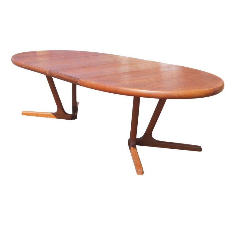 A mid century modern dining table and four chairs made in Denmark by Interform Collection.  Solid teak construction with four side chairs.  The table extends from 68.5