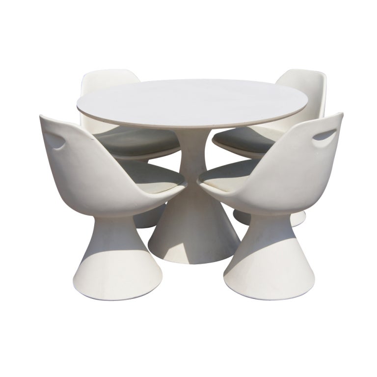 A mid century modern dining table made by Hollen reminiscent of the style of Eero Saarinen.  An eggshell white fiberglass base with white laminate top.  As shown in the last image, we also have a matching set of four chairs on 1stdibs.