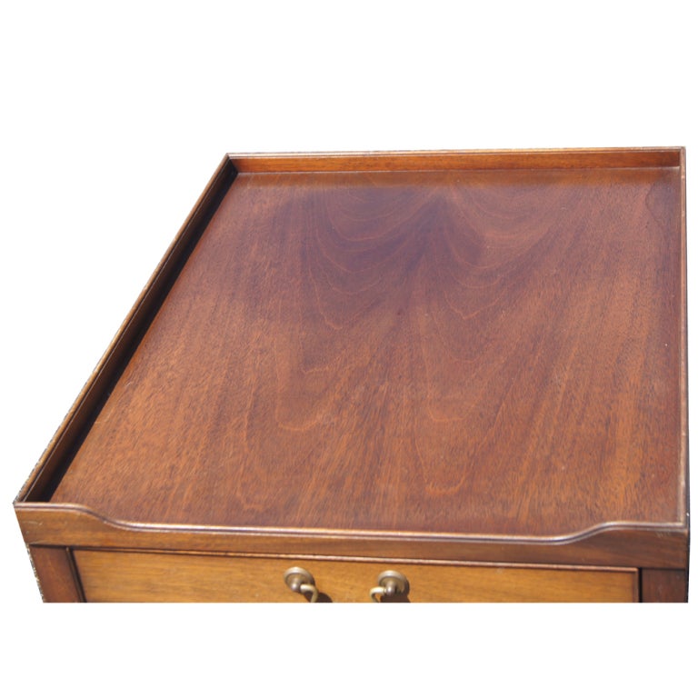 A walnut end table made by Kittinger with one file drawer and one regular drawer.