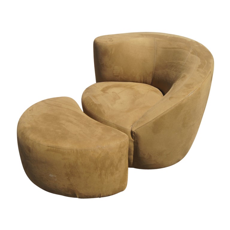 A pair of mid century modern swivel Nautilus lounge chairs and ottomans designed by Vladimir Kagan upholstered in ultra suede.  The ottomans measure 30