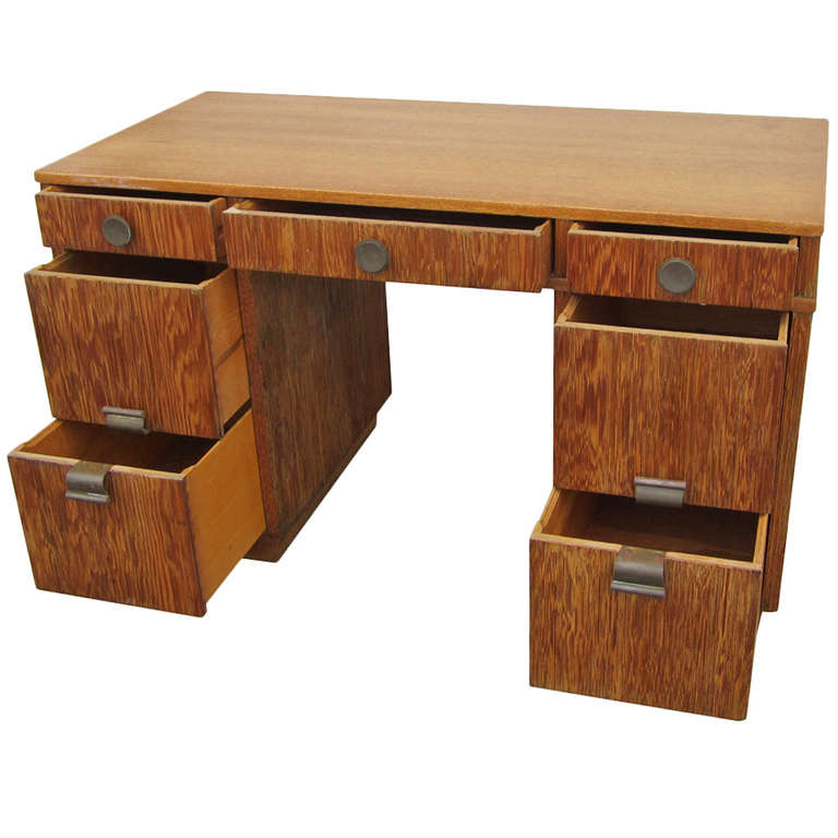 A desk designed by Paul Frankl for Brown and Saltman. This desk features combed wood restored to emphasize the beautiful tones and textures of the natural wood. Three pencil drawers open with round brass knobs while the four file drawers have