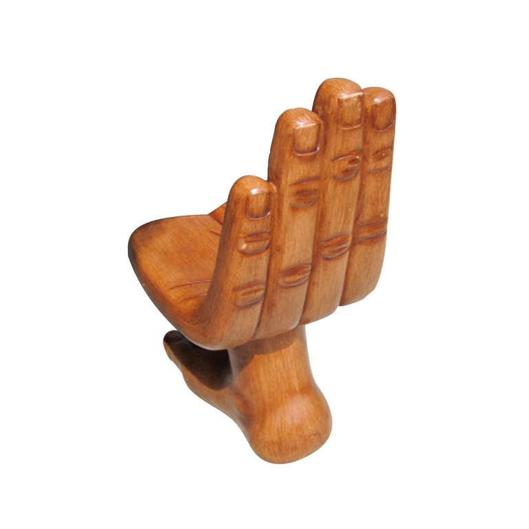 A classic modern sculptural hand and foot chair carved from solid, exotic wood with a natural finish.  Reminiscent of the sculptures produced by Pedro Friedeberg in the 1960's.  Exhibits surrealism and fantastic realism with fine line detail.  Dual