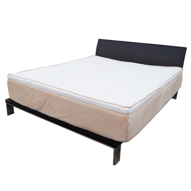 Minimal and sleek bed with an ebonized frame and stainless steel legs and accents.  Mattress not included. This frame slot (60