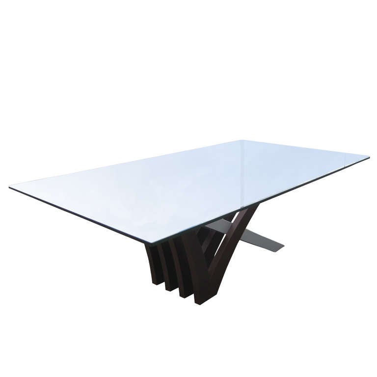 A Mirage dining table made by Rossetto.  The X-base pedestal is made of interlocking planes made of wenge and aluminum.  The top is half inch glass.