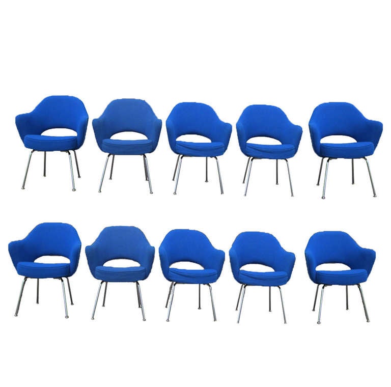 Four vintage, bright-blue Executive arm chairs by Eero Saarinen for Knoll International. 

Steel legs and nearly flawless, blue fabric upholstery make this set an absolute must-have for the forward-thinking office or the home. Stylish curves and