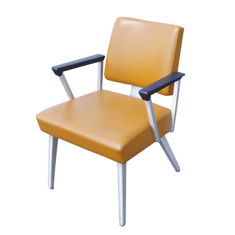 1 General Fireproofing Armchair, constructed of brushed tubular aluminum and covered in mustard yellow vinyl upholstery. These chairs are perfect period pieces and feature an attractive angular design.