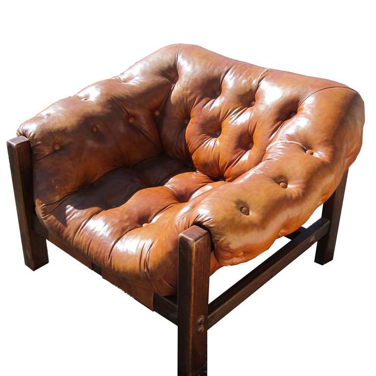 Incredibly comfortable tufted orange fabric lounge chair, wonderful in both scale and form, this chair is made with a solid wood frame and tan/burnt sienna fabric. Two tears in the upholstery, reupholstery available, please inquire.