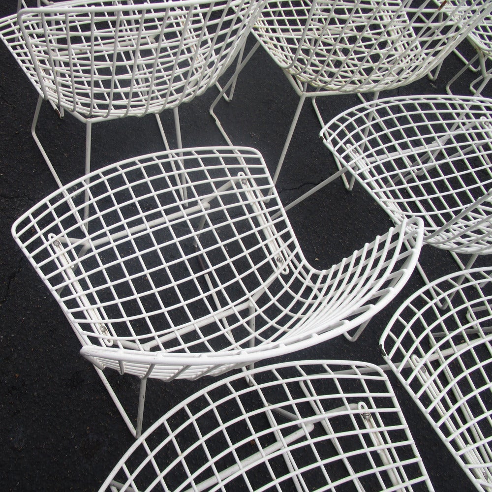 The Bertoia side chair is composed of delicate steel rods that have been precisely interwoven and welded to create airy, sculptural seats. Despite their delicate filigreed appearance, the chairs are supremely strong.  The powder-coated chairs can be