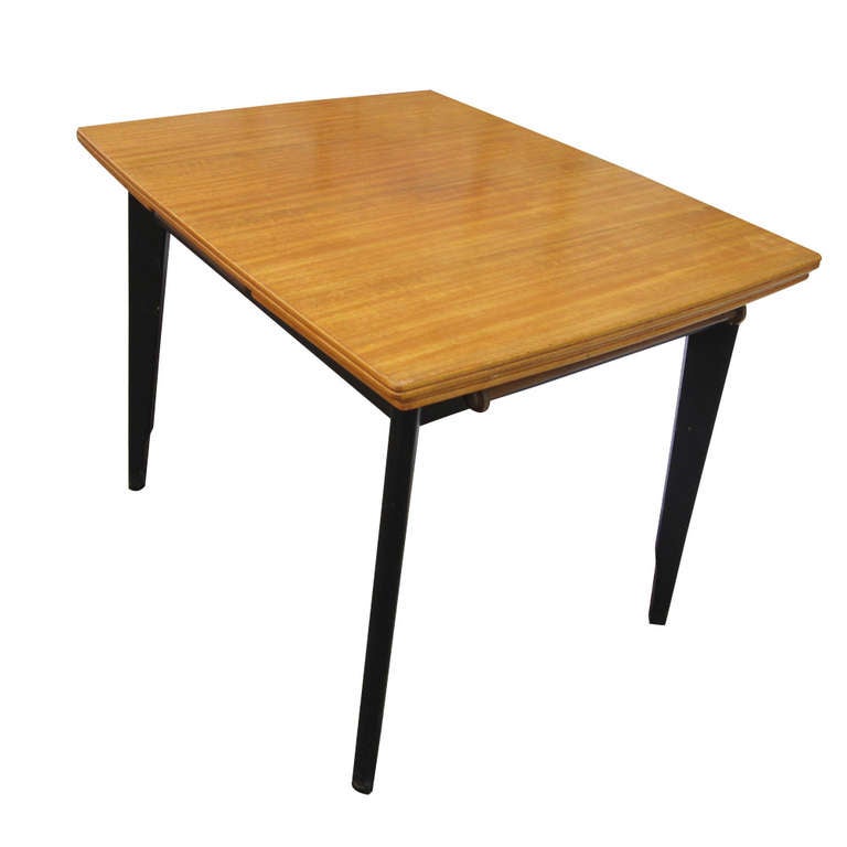 An F.D. Welters Ltd. expandable dining table with a pull-out leaf at each end.  The base, stretchers, and legs are in ebonised wood and the top and leaves are teak.  
Closed: 38