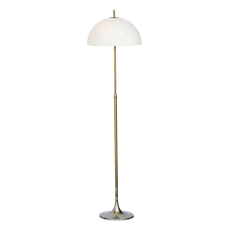 A classic mid century floor lamp made by Laurel Lamp Mfg. Co, Inc.Beautiful brass.  A sturdy base with adjustable support, three lamp sockets, and dome shade.