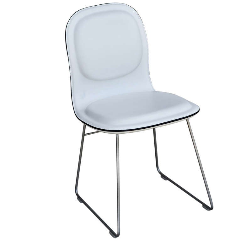 A set of four Hi Pad Cappellini side chairs designed by Jasper Morrison stainless steel bases with white Italian leather seats and backs.