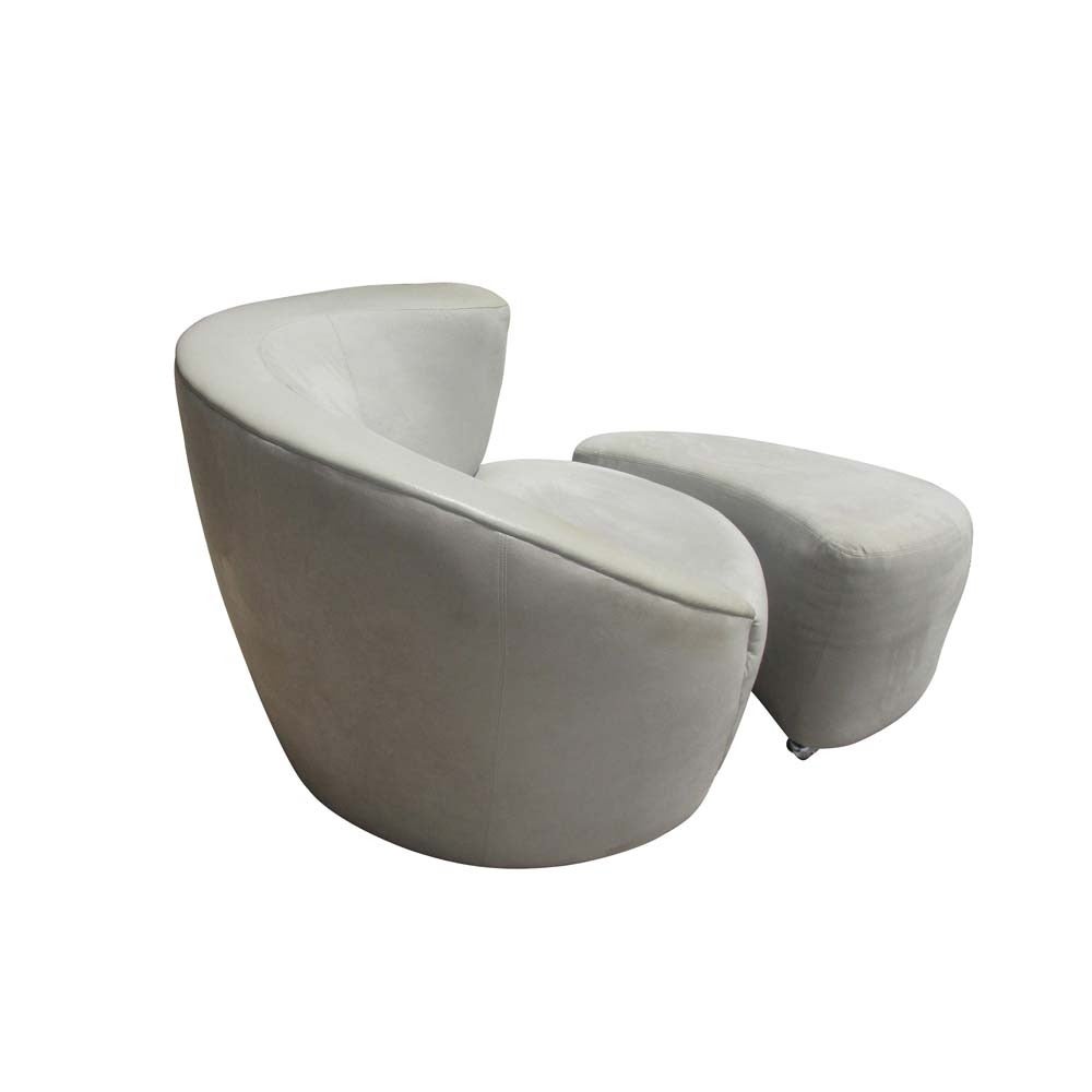 A Classic Nautilus chair designed by Vladimir Kagan for Directional featuring sloping, a asymmetrical backrest. This lounge chair rests upon swiveling a base which allows it to rotate 180 degrees and then return to the original position. This chairs