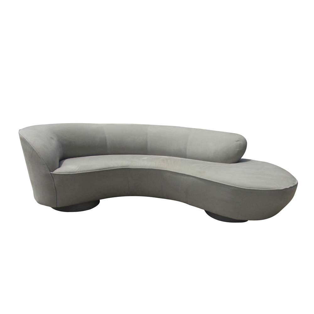 Vintage Mid-Century Modern Vladimir Kagan signature free-form sofa. A free-form curved sofa with extended lounge with a wood base and ivory upholstery.