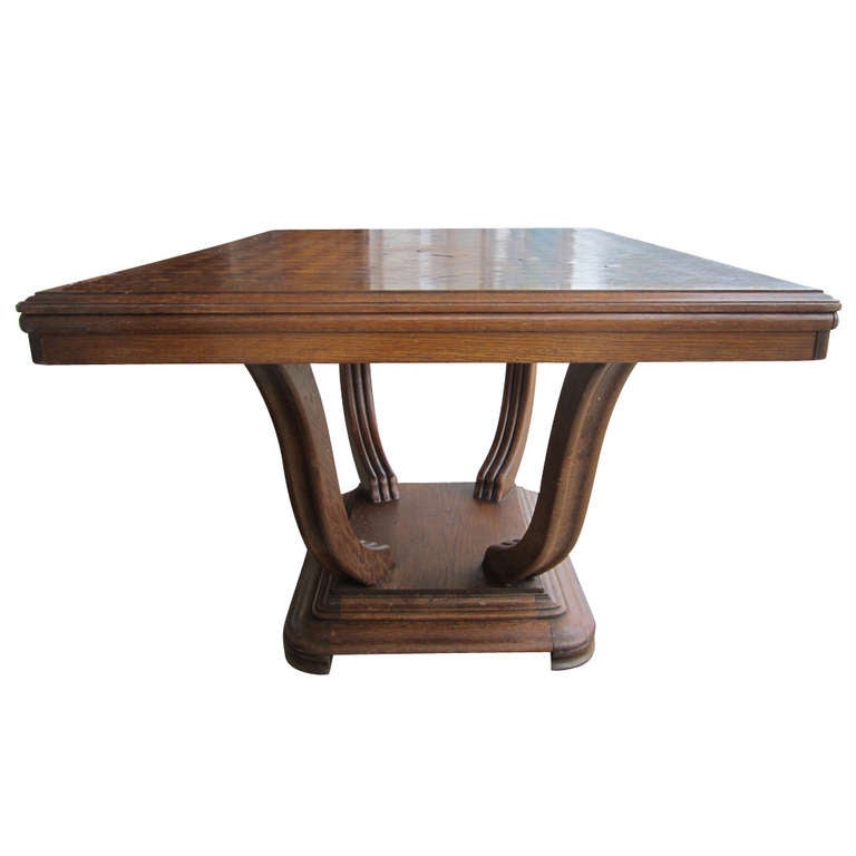 A beautiful Art Deco dining table constructed from oak with a parquet top.  
