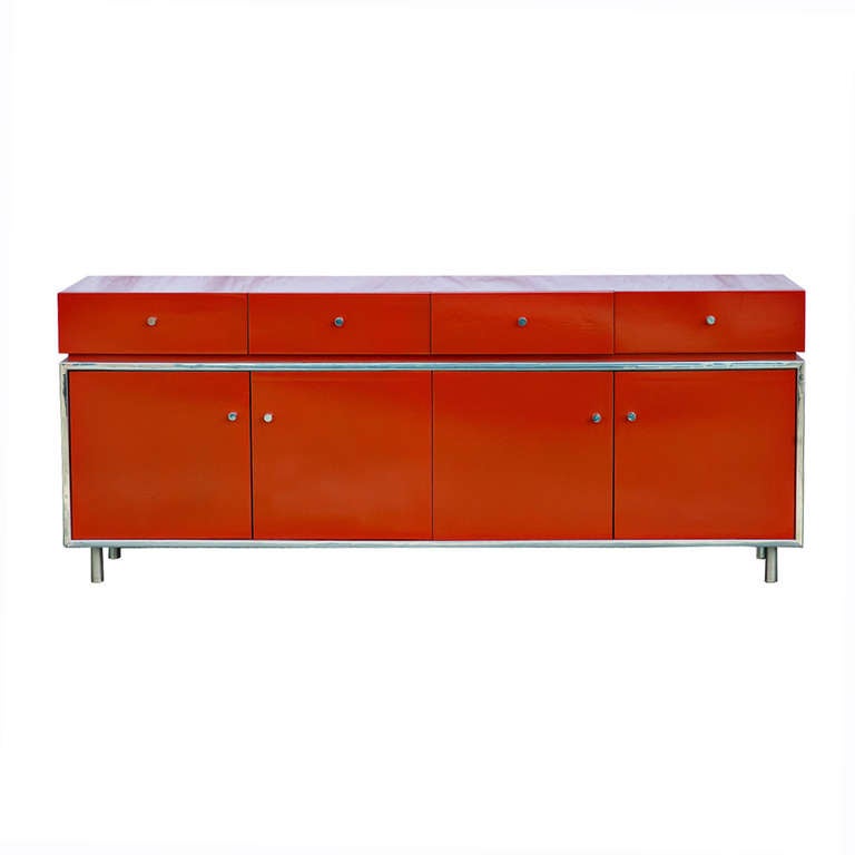 An chic and modern credenza by Thomasville Founders lacquered in orange.  

Credenza features four medium upper drawers and two lower storage cabinets with magnetic door catches.  Legs, drawer pulls, and trim are made of metal.