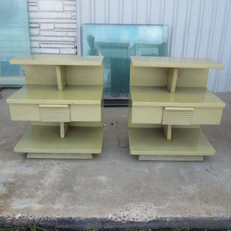 A pair of vintage midcentury night stands manufactured by Kent Coffey, part of the Woodmaster series. These unique nightstands have several ways to store different types of things with a two tiered shelving right above a small drawer and another