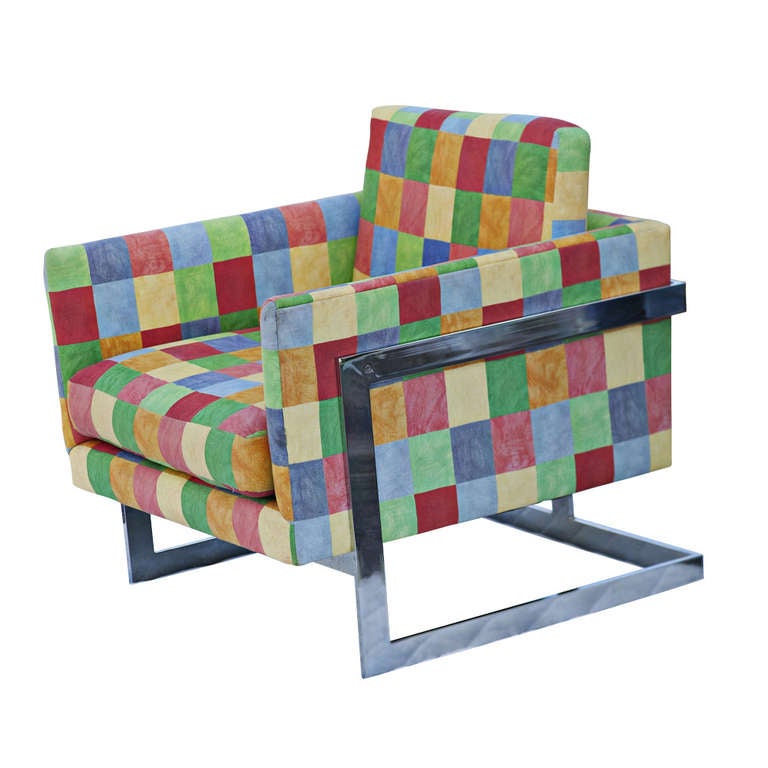 A pair of chrome and multi-colored fabric club chairs by Milo Baughman.  These chairs definitely make a statement for any room.

Small tear in back of one chair