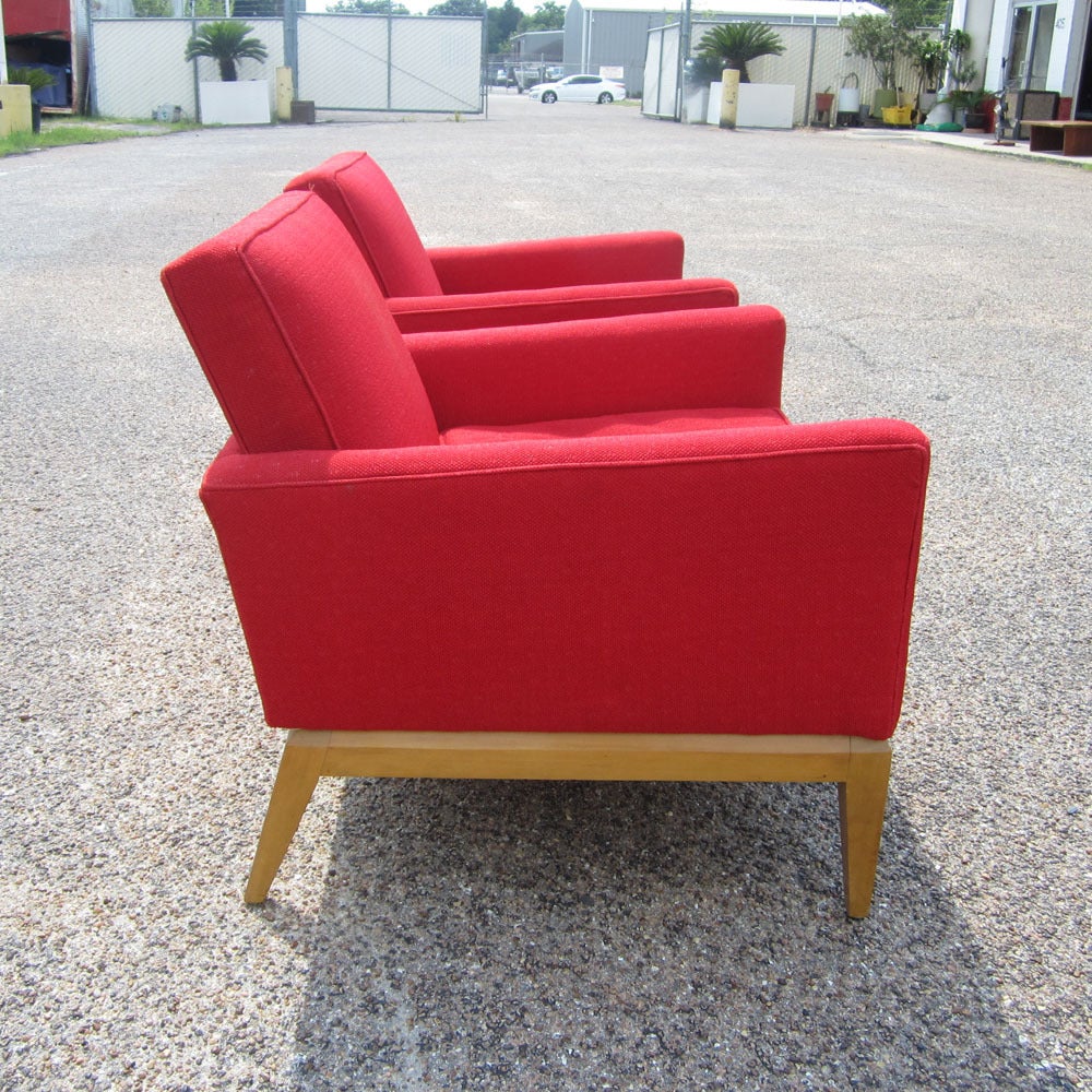 Two vintage Mid-Century lounge chairs by Heywood Wakefield. These chairs feature a stunning red colored fabric, with a strawberry spotted pattern. 

Good condition.  Wheat finish. Made In USA.