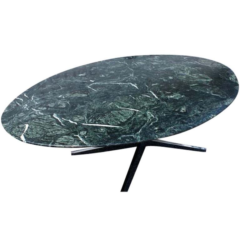 A mid century modern classic dining table or desk designed by Florence Knoll for Knoll Studio.  Chrome four-star base with an oval Verdi Alpi green marble top with a knife edge.