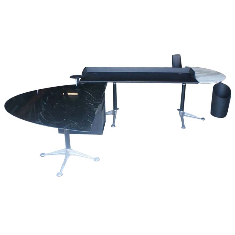A mid century modern office system designed by Bruce Burdick and made by Herman Miller.  Three work surfaces, including one of black marble and one white marble.  One suspended file cabinet, one trash can and other accesories included.  Black marble