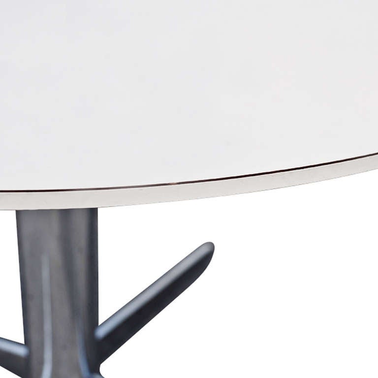 This table has a white laminate top 
 
Aluminum base with gliders

Circa 1975

Made In USA