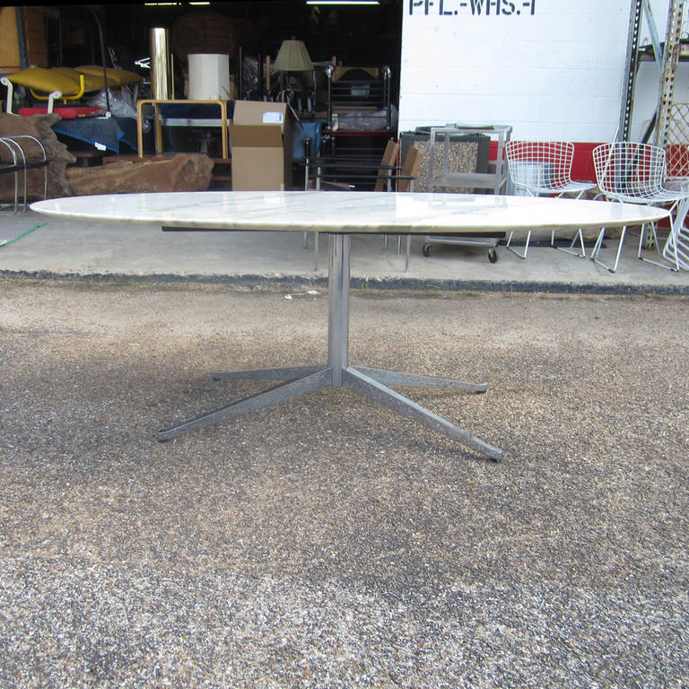 A 6.5 ft oval desk or table designed by Florence Knoll for Knoll Studios. A polished chrome base with a knife edged Calcutta marble table top. This lovely table will serve excellently in both a domestic and an office setting. Matching credenza also