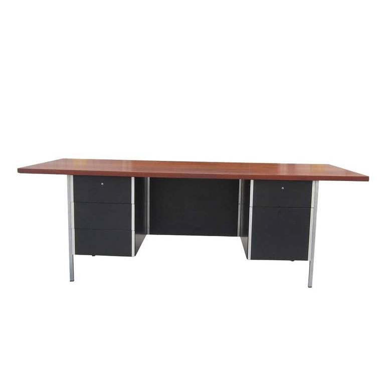 A vintage walnut and chrome double pedestal executive desk designed by Florence Knoll for Knoll. Measures 7ft.