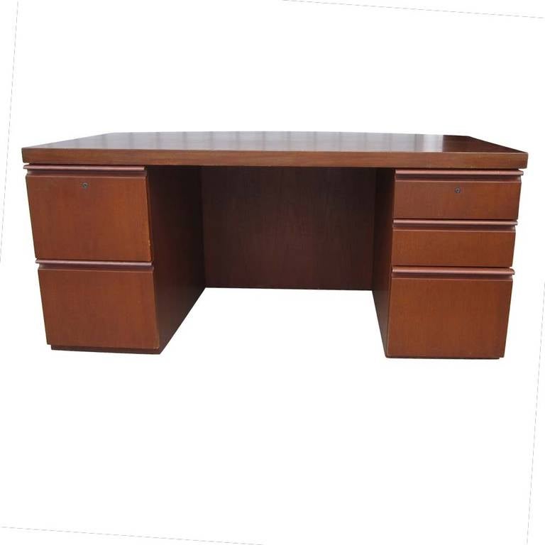 A vintage five foot walnut double pedestal executive desk designed by Gwathmey and Siegel for Knoll. This desk features a very nice curve along the tabletop and five drawers with a lock.