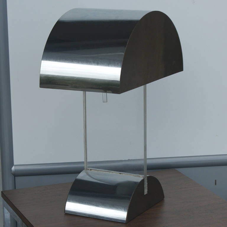 A pair vintage chrome and Lucite desk lamps by Pierre Cardin, USA, circa 1970s. Polished chrome and Lucite arc designed shade and matching base separated by a substantial Lucite (acrylic or perspex) support with almost invisible wiring. Double