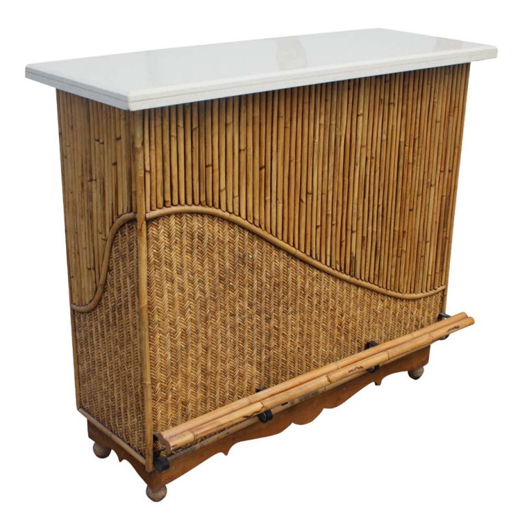 A vintage bar made of rattan with a white granite top and two rattan barstools with upholstered fabric seats.  The bar has ample shelved storage.  

The barstools measure 45