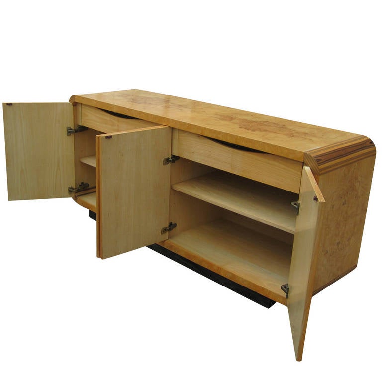 Olivewood Burl

Two Pull Out Drawers

Ample Shelving

Plinth Base