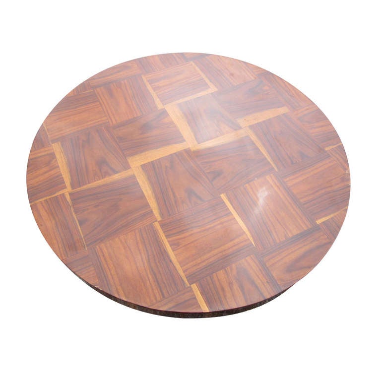 Table features a round top with inlaid marquetry 
supported by four curvilinear supports with 
a center ball accent on a four star ebonized base.