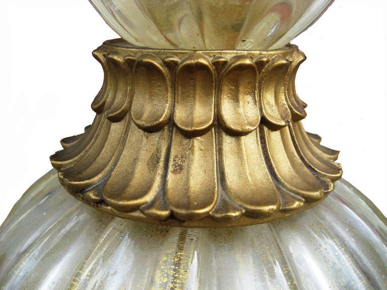 A wonderful Venetian lamp, made on the island of Murano, near Venice, Italy. This piece was made by Barovier e Toso, and possibly designed by the renowned Italian designer Ercole Barovier. Made in clear + red glass with loads of gold leaf inclusions