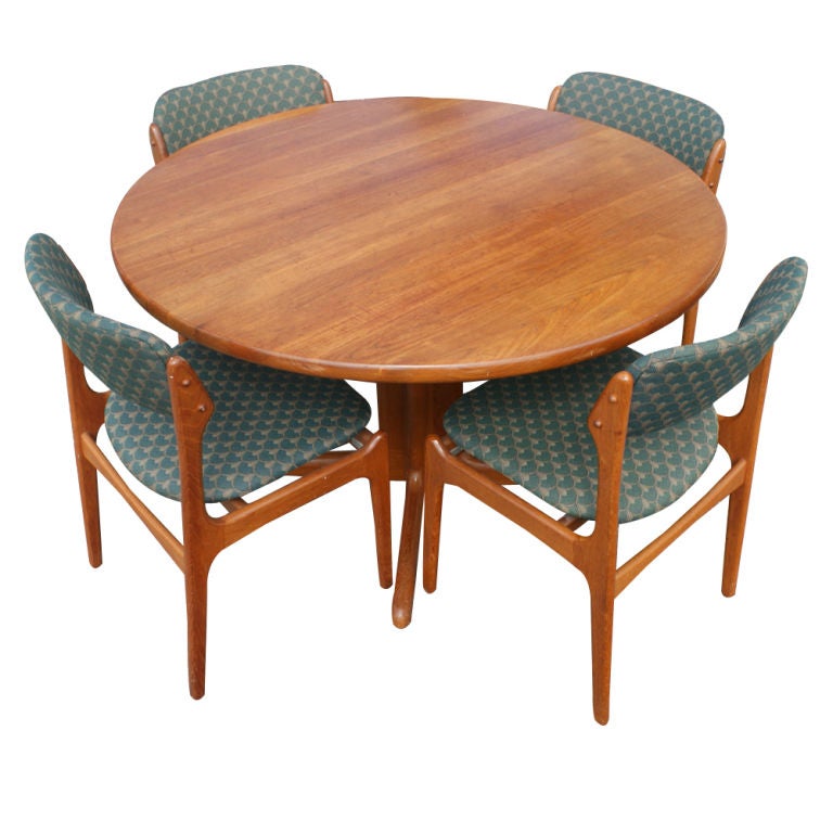 A set of mid century modern Danish dining furniture consisting of a table designed by Niels O. Møller and made by Gudme Møbelfabrik and six dining chairs designed by Erik Buch and made by O.D. Mobler.  The teak table 47