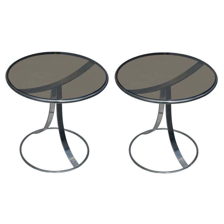A mid century modern pair of side tables designed by Gardner Leaver and made by Steelcase.  Stainless steel with a smoked glass top.  We also have a matching coffee table available on 1stdibs as shown in the last image.