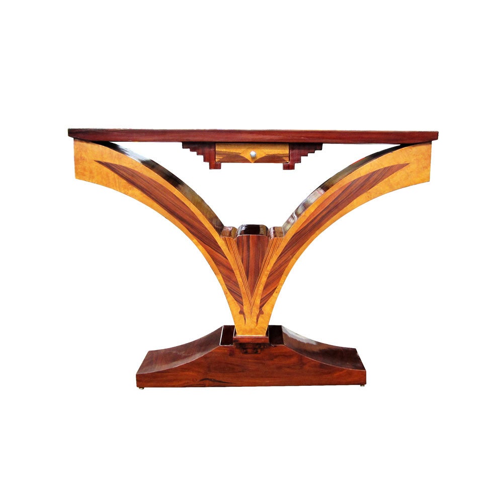 A unique console table constructed of several exotic woods, with a single drawer and metal pull. A stylish piece sure to complement an entrance hall or living space.