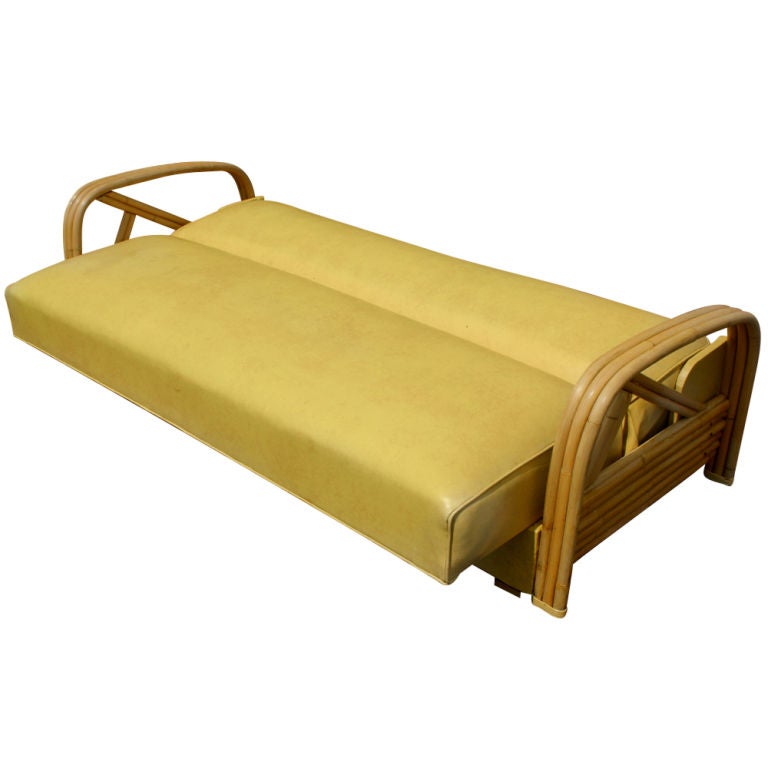 A mid century modern sofa made by Ritts Tropitan that converts into a bed in the style of Paul Frankl.  Bamboo frame with the original vinyl upholstery.  Reupholstery is available in the customer's own material at no additional cost.  We also have