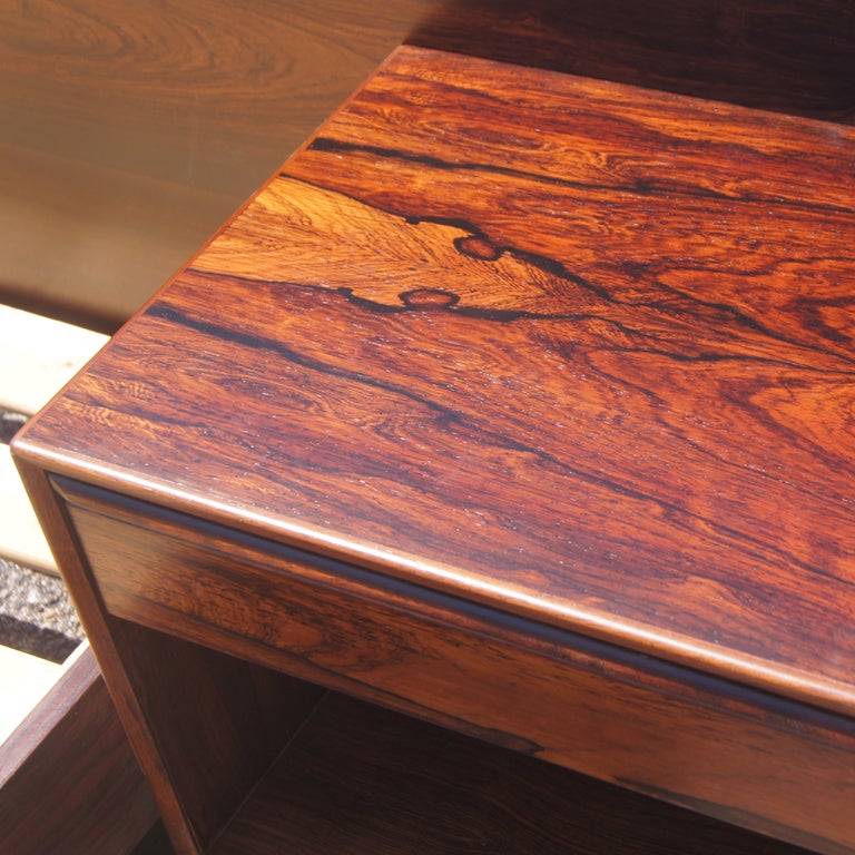 A mid century modern rosewood platform bed with attached nightstands made by Westnofa.  The platform measures 81