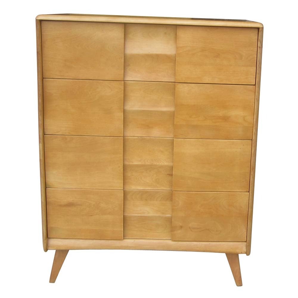 A vintage birch Heywood-Wakefield highboy dresser from the trophy suite. This dresser has four large drawers with sculptural handles and faces with very interesting concave and convex curves. A very nice piece and a wonderful example of the unique