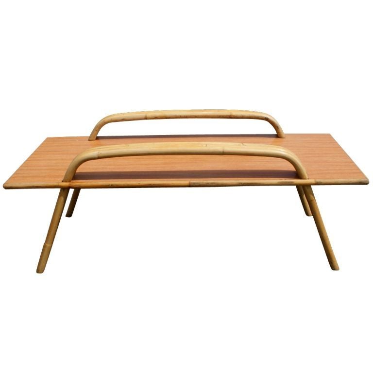 A mid century modern coffee table by Ritts Tropitan in the style of Paul Frankl. Bamboo frame with laminate wood top.  We also have several matching pieces of bamboo furniture available on 1stdibs, as shown in the last image.