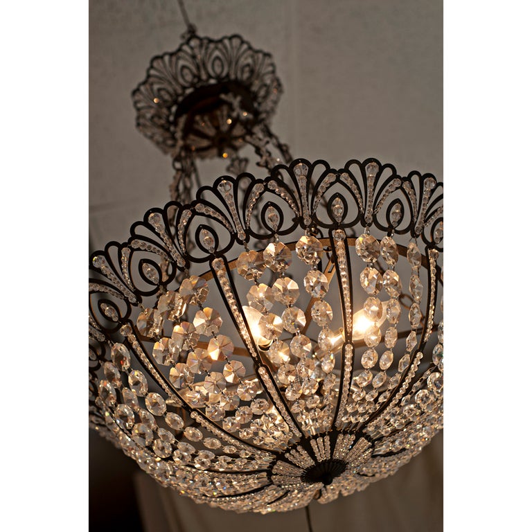 A Tiara chandelier made by Schonbek.  A lacy bronze umber metal framework fitted with Spectra crystal jewelry beads.