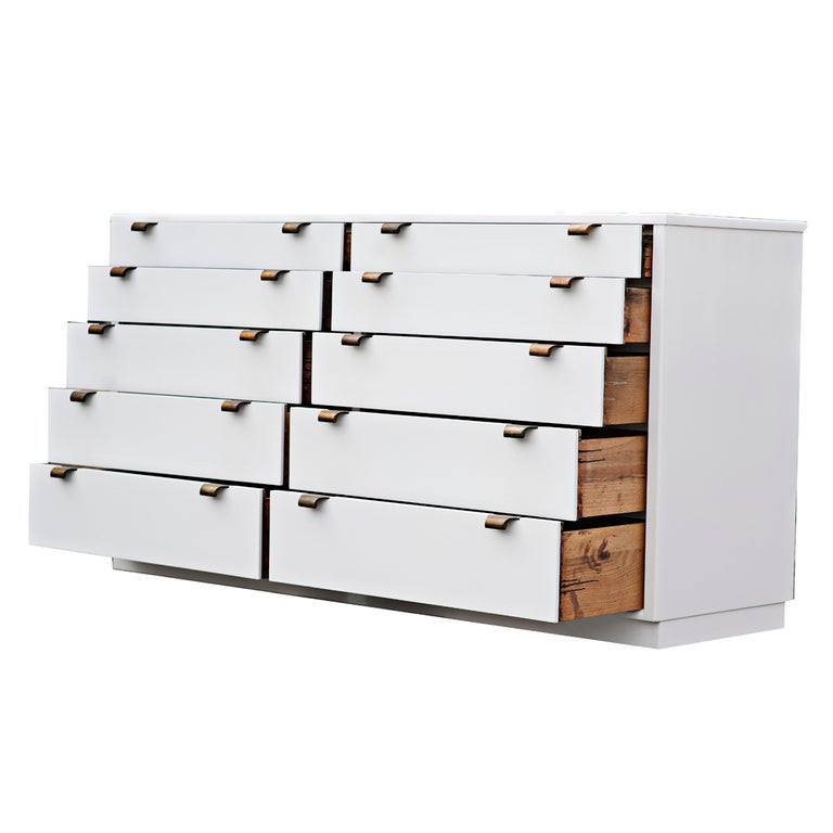 A mid century modern ten drawer dresser designed by Edward Wormley and made by Drexel.  Part of the Precedent series, it is newly finished in white lacquer, it is an elegant addition to any interior.