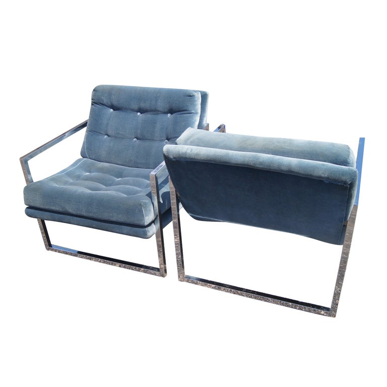 A pair of mid century modern lounge chairs in the manner of Milo Baughman.  Square tubular chrome frames with button-tufted seats and backs.