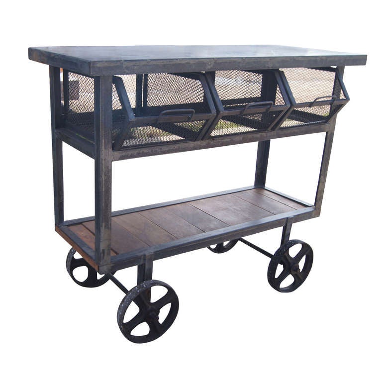 Heavy duty industrial rolling cart with large metal wheels, removable basket and inserted wood shelf at the bottom.