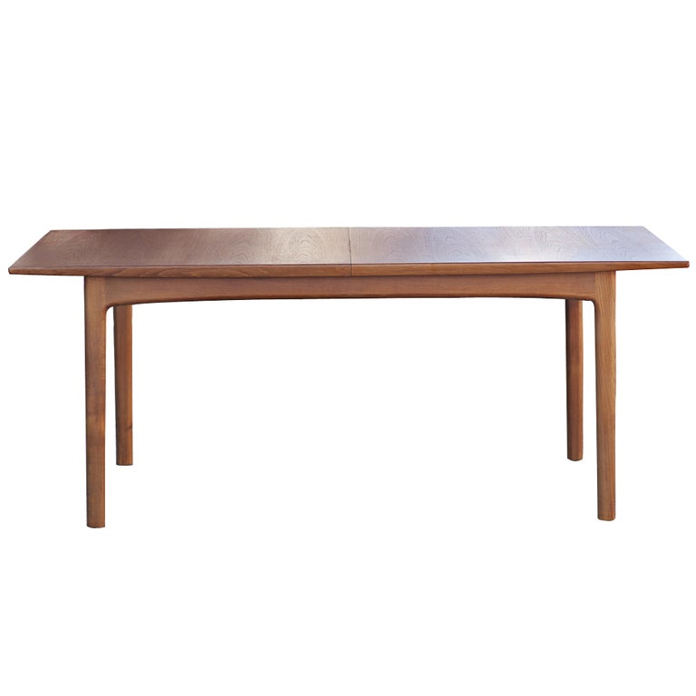 A mid century modern teak dining table designed by Folke Ohlsson and made by Dux.  The table expands from 80