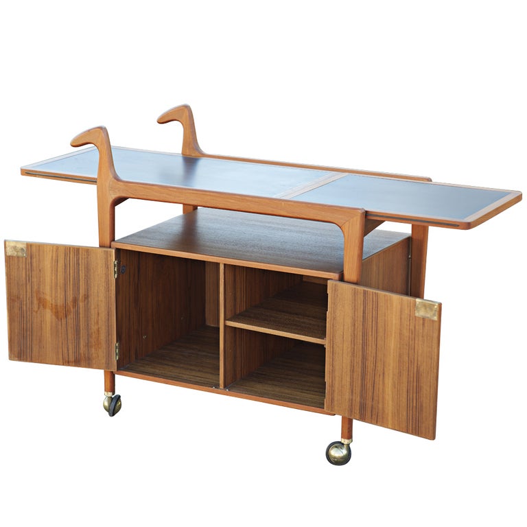A mid century modern Scandinavian tea cart or trolley made by Falster Møbelfabrik.  Teak construction with an expandable, slate inset top that opens to 56