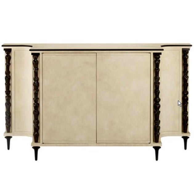 An Indochine buffet or cabinet designed by Andre Arbus and made by Baker.  Parchment on hardwood with decorative bronze columns, feet, and ornament.  Two doors concealing shelved storage and a fitted flatware drawer.