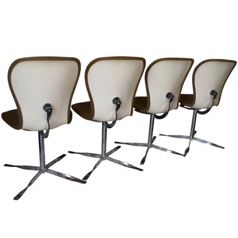 A set of four mid century modern fiberglass and chrome Ion chairs upholstered in a padded golden-brown fabric. Designed by Gideon Kramer for the American Desk Company, these chairs were introduced at the Seattle World's Fair in 1962.